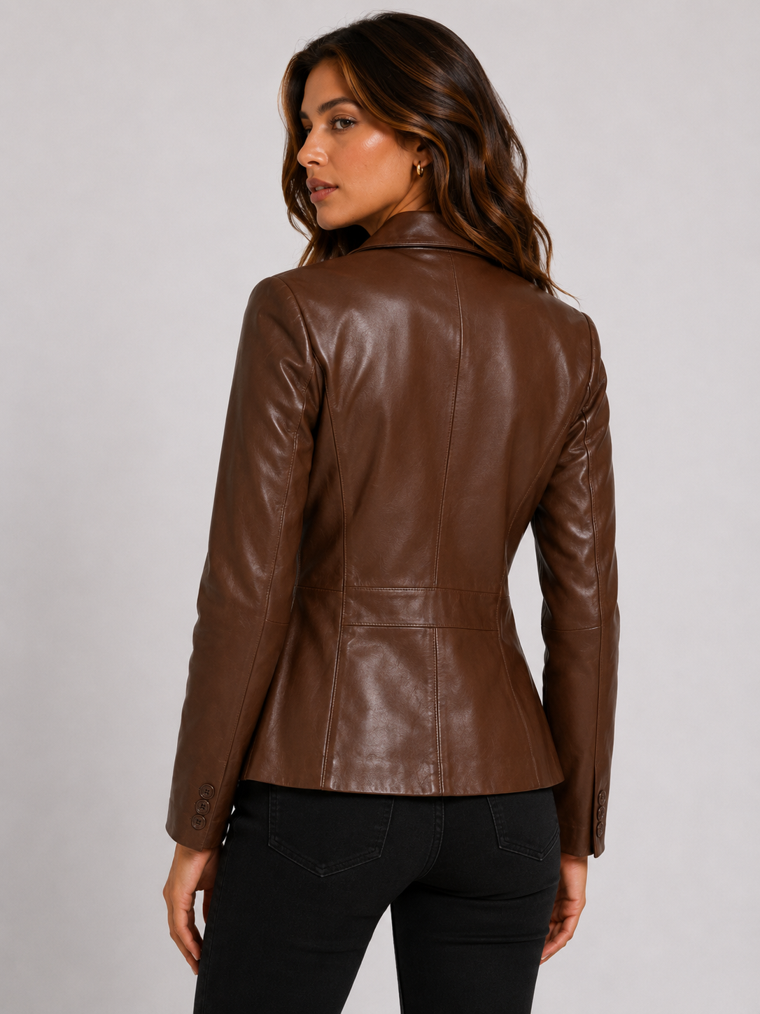 94a214bf-036d-4e9c-adef-7c70a132548d Women's brown genuine leather blazer jacket with a tailored single-breasted design, notch lapel collar, full-length sleeves, and front flap pockets.